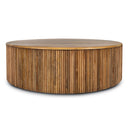 Sincere round wood drum coffee table side studio view showcasing vertical fluted detailing