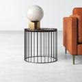 Morgan dark brown wood top round end table with black iron cage base styled next to a couch