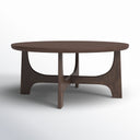 Skyler round walnut brown wood coffee table three-quarter studio view showcasing cross arched pedestal base