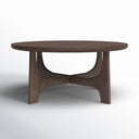 Skyler round walnut brown wood coffee table low-angle studio view highlighting architectural cross arched base