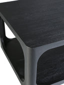 Close up corner view of Kingsley black wood coffee table showing rounded edges and open storage shelf grain
