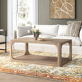 Kingsley rectangular light wood coffee table with open shelf and curved cutout frame in a living room