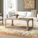 Kingsley rectangular light wood coffee table with open shelf and curved cutout frame in a living room