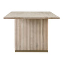 Close-up of the Tripp Dining Table pedestal showing vertical fluted wood detailing and a contrasting brass-tone base trim.