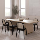 Tripp 6 Seater Dining Table styled with six black and natural cane dining chairs in a contemporary dining room.