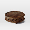 Chandler round carved wood coffee table alternative three-quarter studio view
