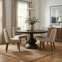 Detailed close-up of the Musa dining table edge revealing the dark wood finish, rounded contour and visible grain along the tabletop.