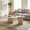 Aidan Cross Legs End Table set styled in front of a large sectional sofa with floor-to-ceiling windows.