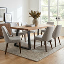 Emir Solid 6 Seater Dining Table styled with six upholstered dining chairs in a warm, contemporary dining room.