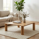 Axton square natural oak coffee table with chunky rounded corner legs styled in a living room
