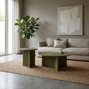 Aidan Cross Legs End Table duo displayed on a textured rug beside a neutral sofa and indoor plant.