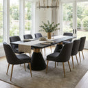 Skyler black rectangular dining table surrounded by upholstered chairs in an elegant dining room with pendant lighting and artwork.