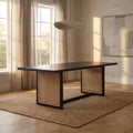Dennis Woven Rectangle 6 Seater Dining Table in black with woven cane panel legs styled in a warm modern dining room.