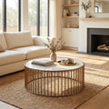 Zain round white marble drum coffee table with gold metal cage slatted base styled in a room