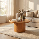 Paxton round wood pedestal coffee table with tray lip top styled in a warm living room