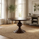 Dark brown Hugh Round Dining Table shown on a white background, highlighting its circular tabletop, sculptural pedestal, and wide stepped base.