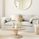Leandro round natural wood coffee table with stacked goblet pedestal base in a bright living room
