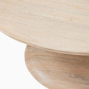 Close up angle view of Leandro coffee table showing curved tabletop edge and natural mango wood grain base
