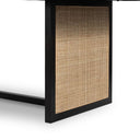 Close-up of the Dennis Woven Dining Table showing the natural woven cane panel framed by a black wooden structure.