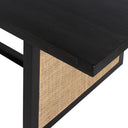 Close detail of a woven cane side panel on the Dennis Rectangle Dining Table with its contrasting dark frame.