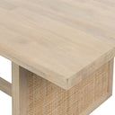  Close-up of the natural Dennis Woven Dining Table corner revealing the pale wood surface and woven cane detailing.
