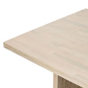 Detailed view of the Dennis Woven Dining Table tabletop edge and textured woven side panel in a light wood finish.